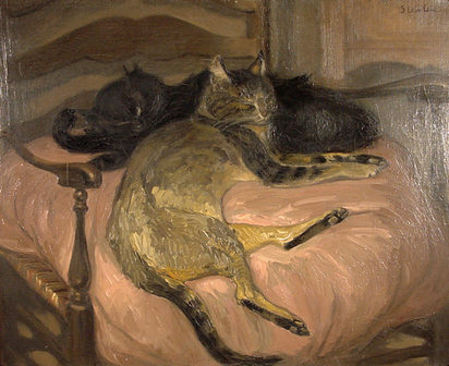Deux chats se reposant dans un fauteuil