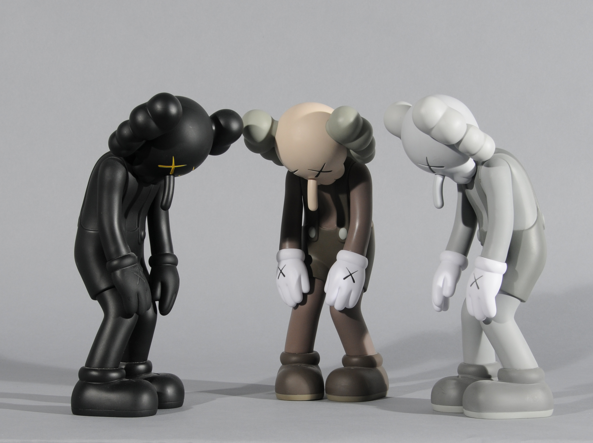 KAWS (Brian Donnelly), 3 multiples: Small lie (Black, Brown, Grey)